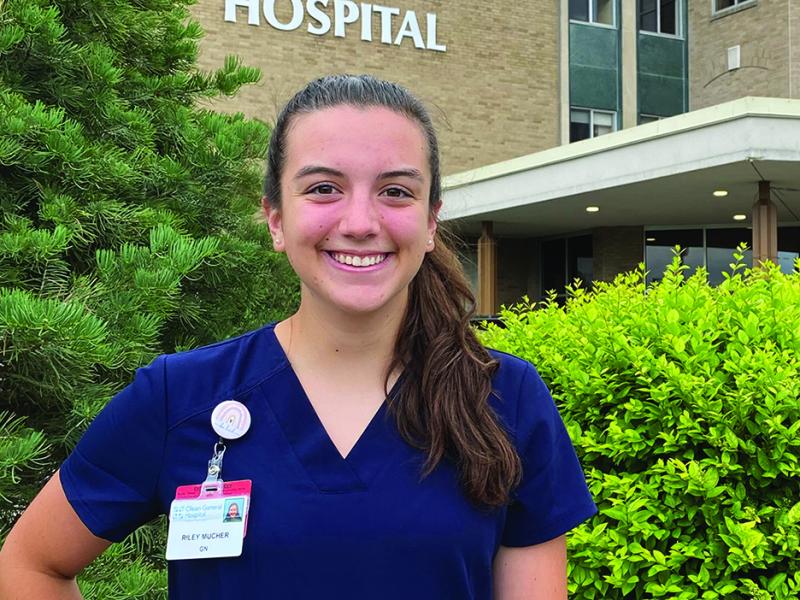 Riley Mucher stands outside a hospital