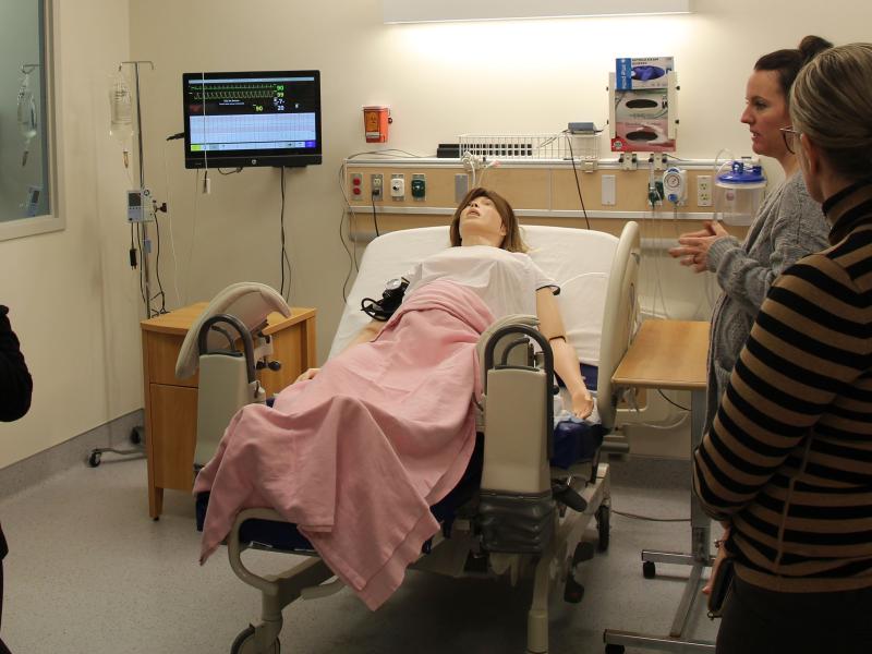Alfred State assistant nursing professor Tara Histed shows a group of attendees to the healthcare forum one of the simulation labs that students receive hands-on instruction.
