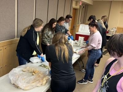 Students prepare chicken barbecue dinners