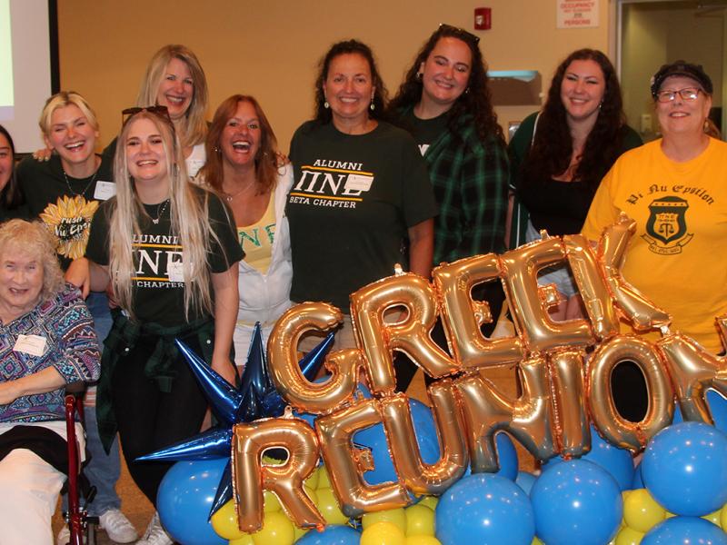 member of Pi Nu Epsilon pose at the Greek Reunion