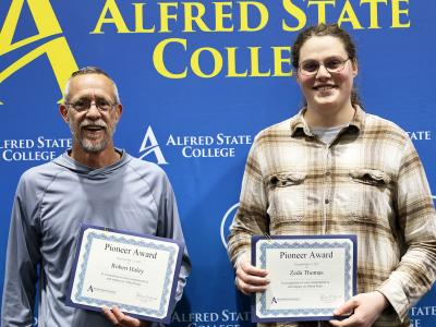 Bob Haley and Zeda Thomas display their awards