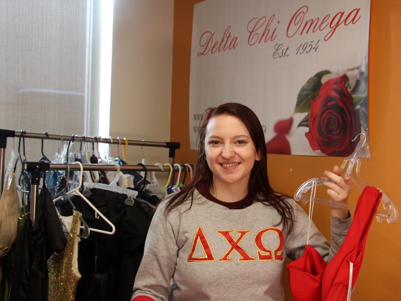 students holding a dress