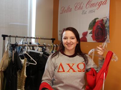 Delta Chi Omega sister Jenna Plouse shows off one of the dresses that will be available at Project Prom Dress. The event will be held April 8 in the Pioneer Center.
