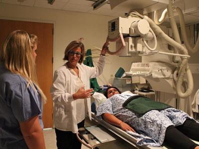 Students and instructor use medical imaging equipment