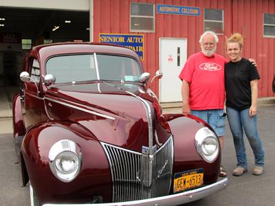 Abigail Clark and her grandfather Jim White stand outside the refinished 1940 Ford Coupe.