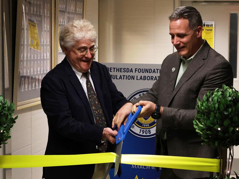 Dr. Mauro and Rob Price cut the ribbon of the new birthing simulator laboratory