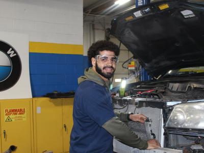 Benjamin Rivera works on a car in the automotive shop