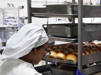 student works on rolls