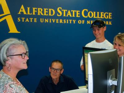 A family meets with an Alfred State financial aid representative.