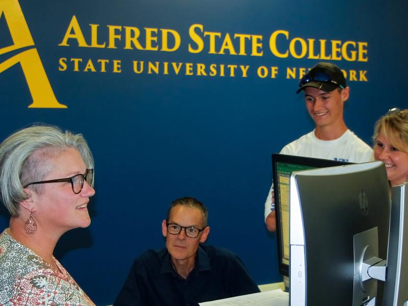 A family meets with an Alfred State financial aid representative.