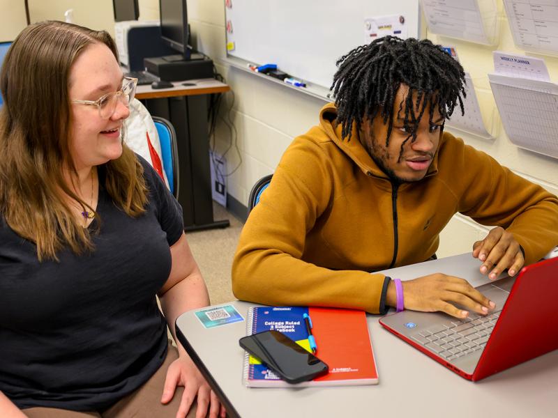 Tutor working with a student on science homework