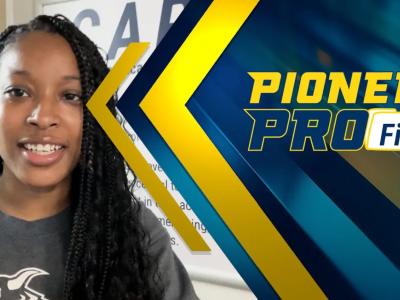 Student stands in student success center