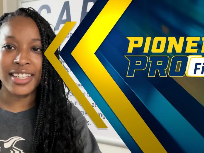 Student stands in student success center