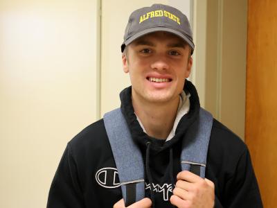 Student smiling in the hallway