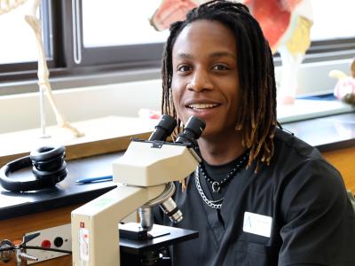 student works with a microscope