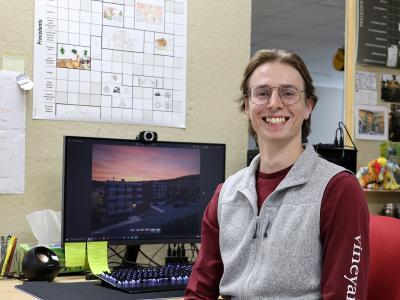 student sits at his desk in front of his architecture projects