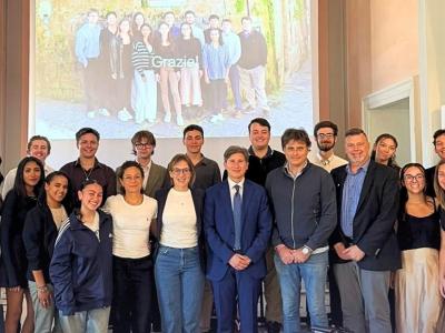 students pose after presenting in a class