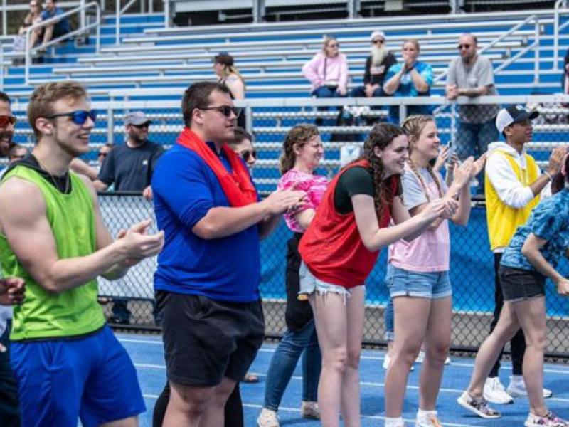 Students cheer on athletes at the finish line