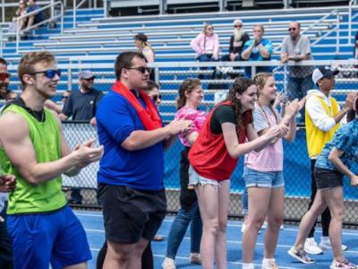 Students cheer on athletes at the finish line