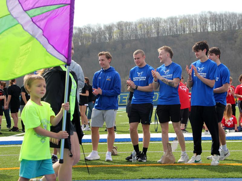 student-athletes cheer on special Olympic athletes