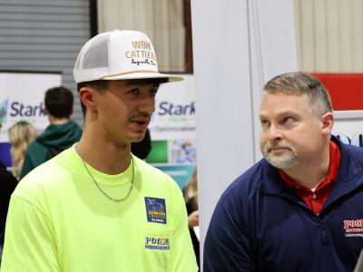 Noah Springer talks to current students at a career fair