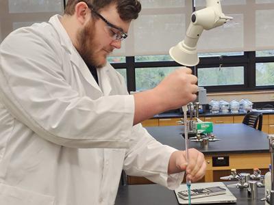 An Alfred State student works in a lab. Alfred State ranks high with health, science, and human services majors.