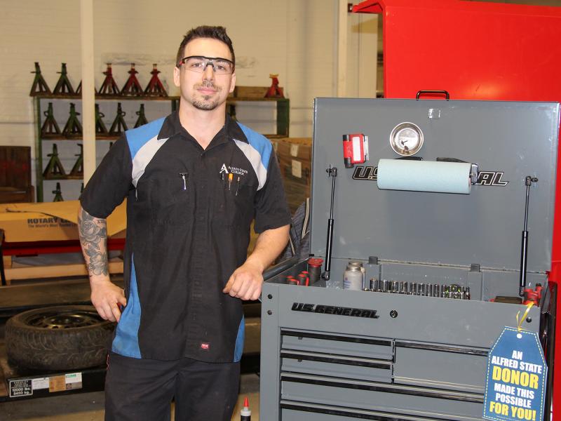 student standing near tool box
