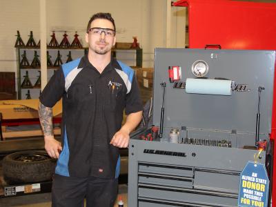 student standing near tool box