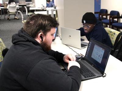 A pair of Alfred State students work together in the Student Success Center.