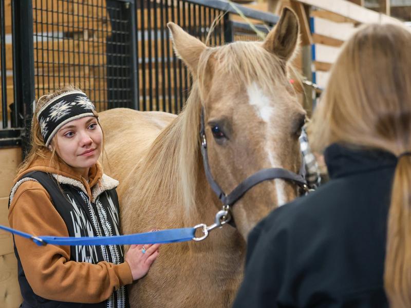 student with a horse