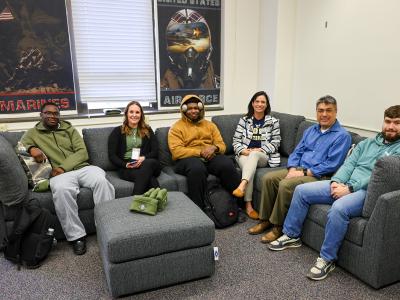 Veteran students sit on new furniture in Veteran's Loung