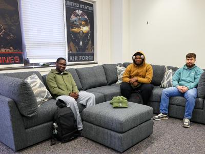 Veteran students sit on a couch