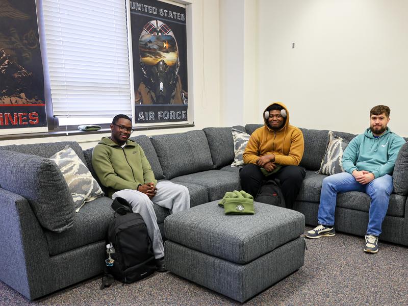 Veteran students sit on a couch