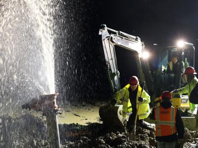 Students work on a water main break