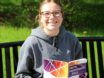 Andi Williamson, who received a scholarship to attend Alfred State, studies outside the Hinkle Library.