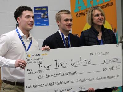 students pose with a check