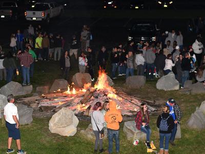 Students gather around a bonfire