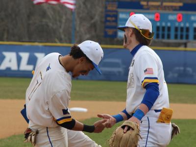 Alfred State baseball players Elijah Barinas and Devin Mersmann celebrate the end of an inning during a game earlier in the season.