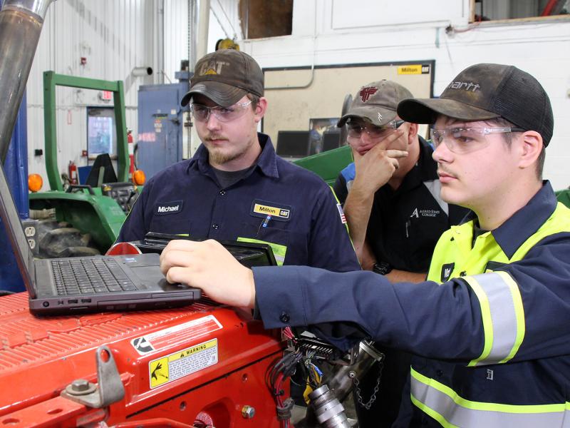students work on a laptop in the diesel lab
