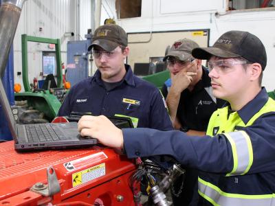 students work on a laptop in the diesel lab