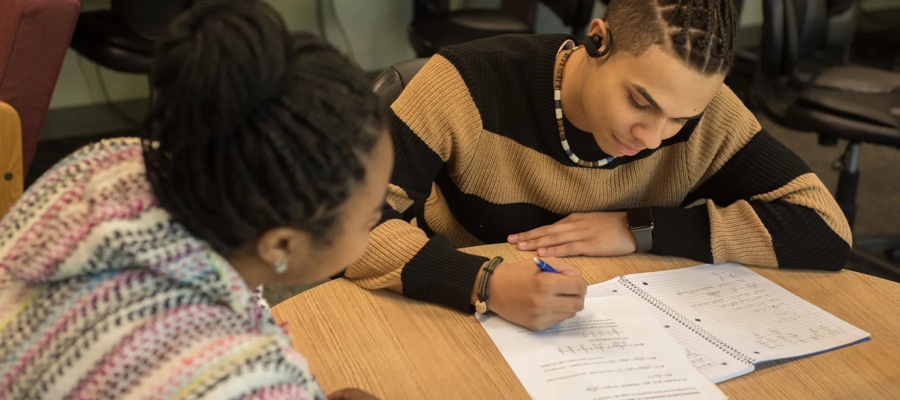 A student receiving tutoring from a professor.
