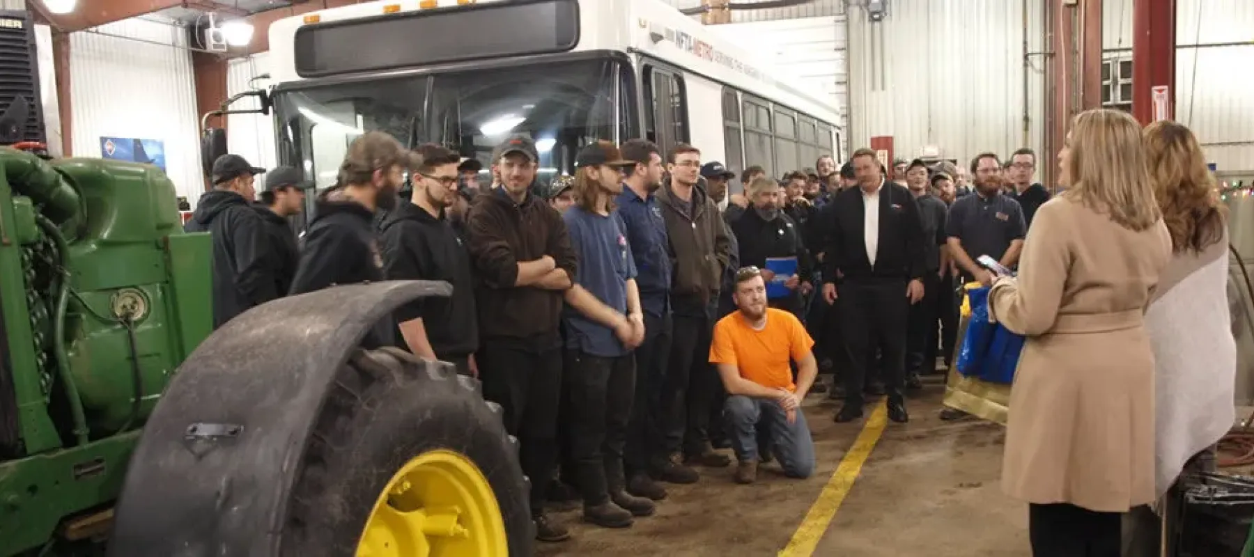 Heavy Equipment, Truck & Diesel Technician students gathered next to bus.