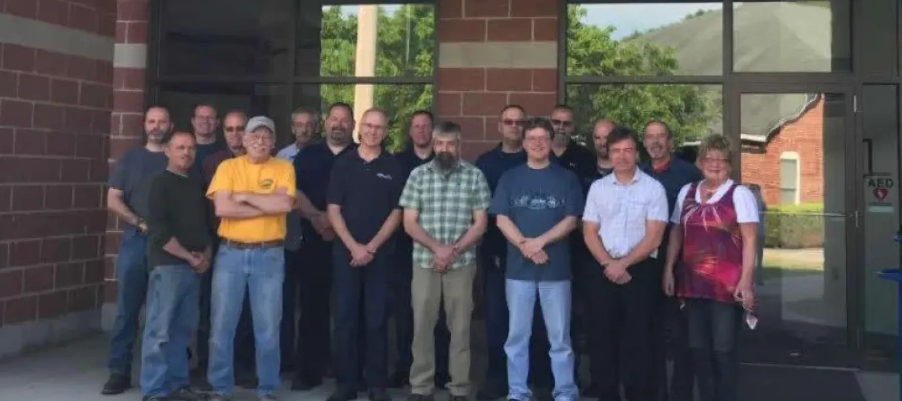 Faculty & Staff gathered outside building on Wellsville campus.