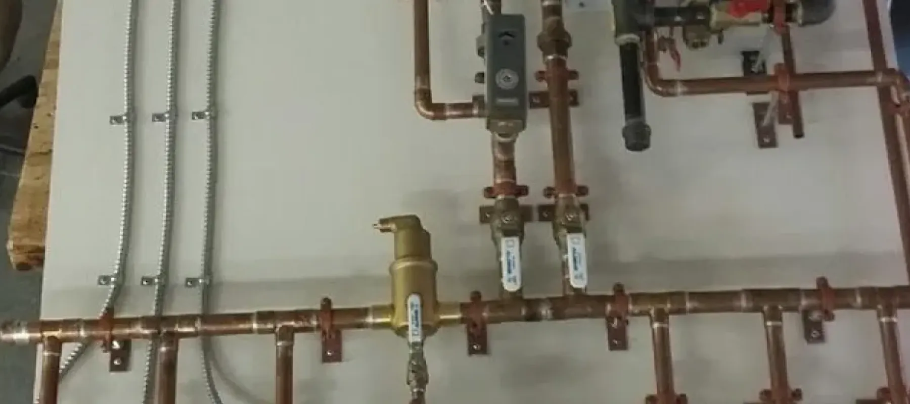 Various connected pipes attached to board.