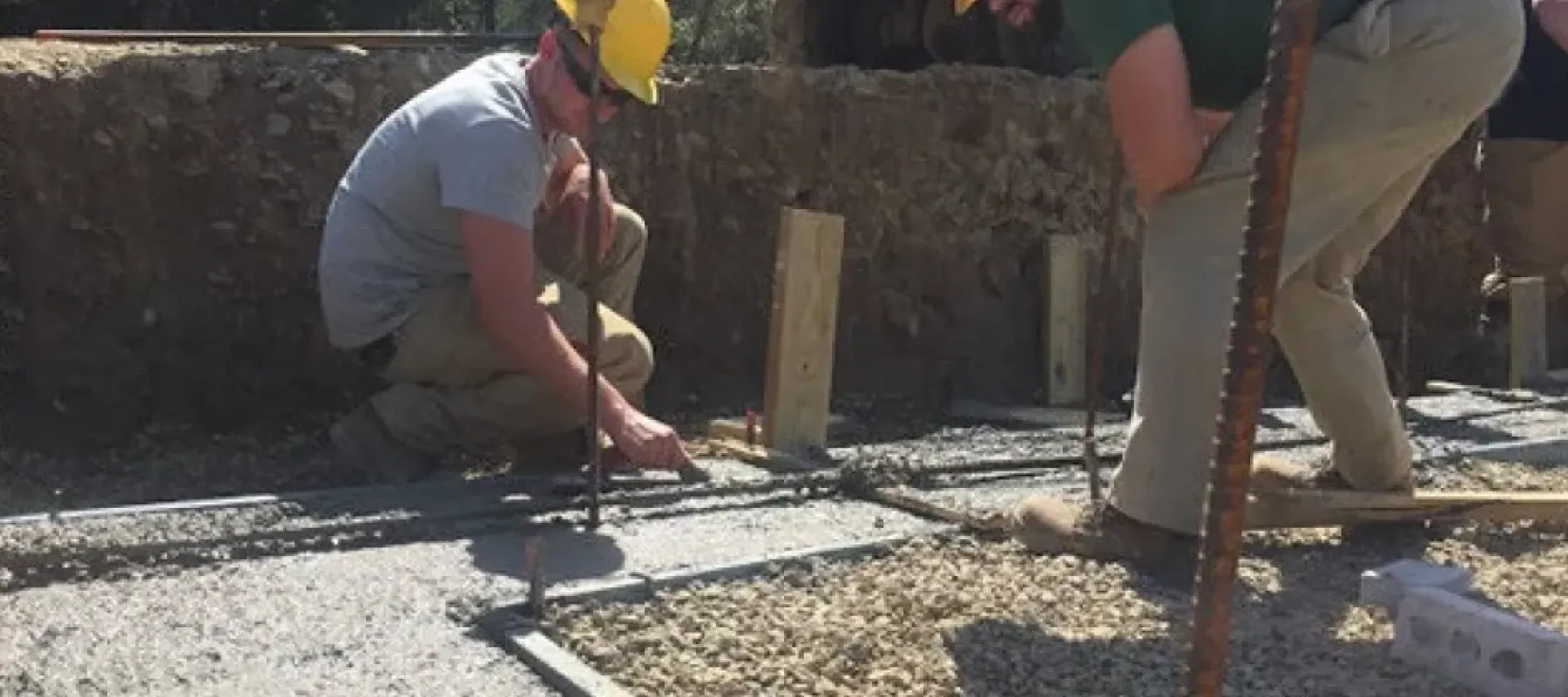 Man working on concrete for building foundation.