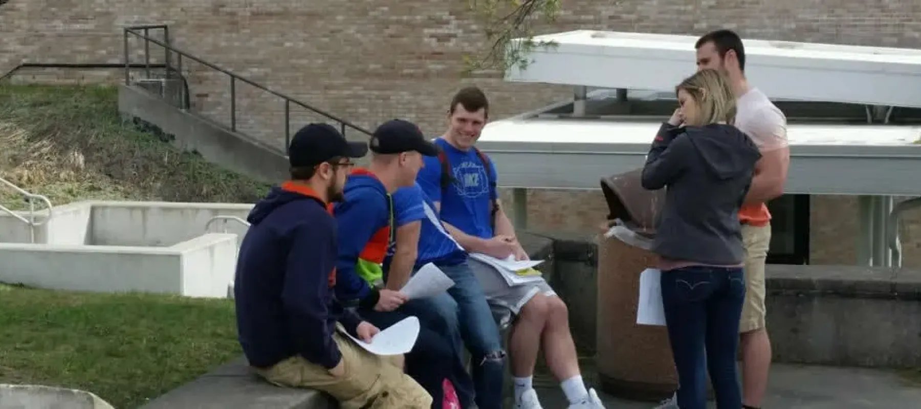 Students sitting outside on campus.