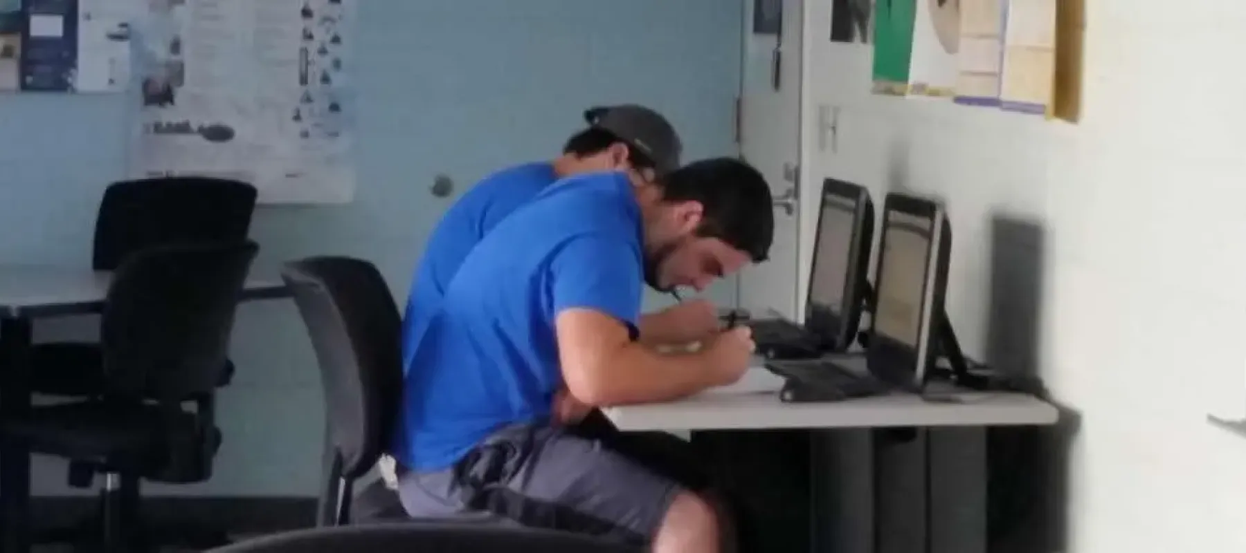Students working on schoolwork in front of computers.