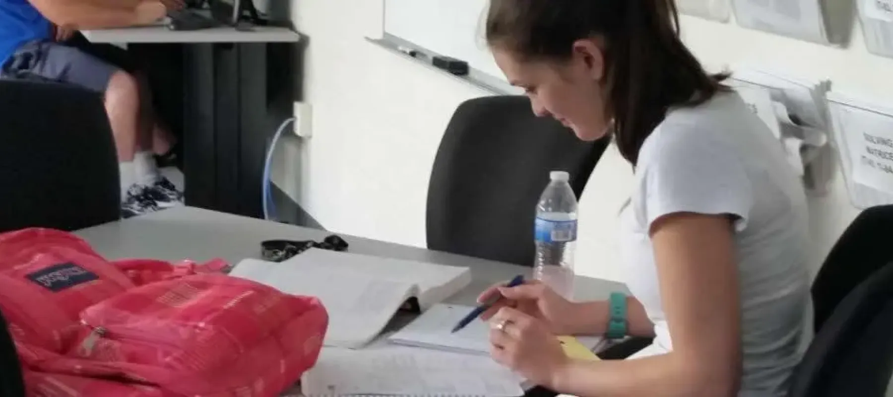 Student sitting at desk working on assignment.