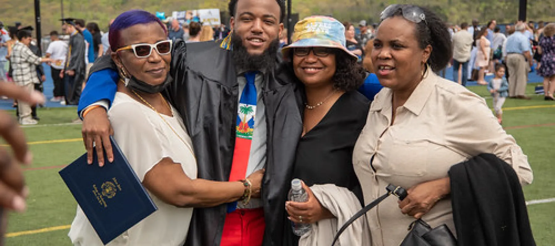 Student with family at graduation.