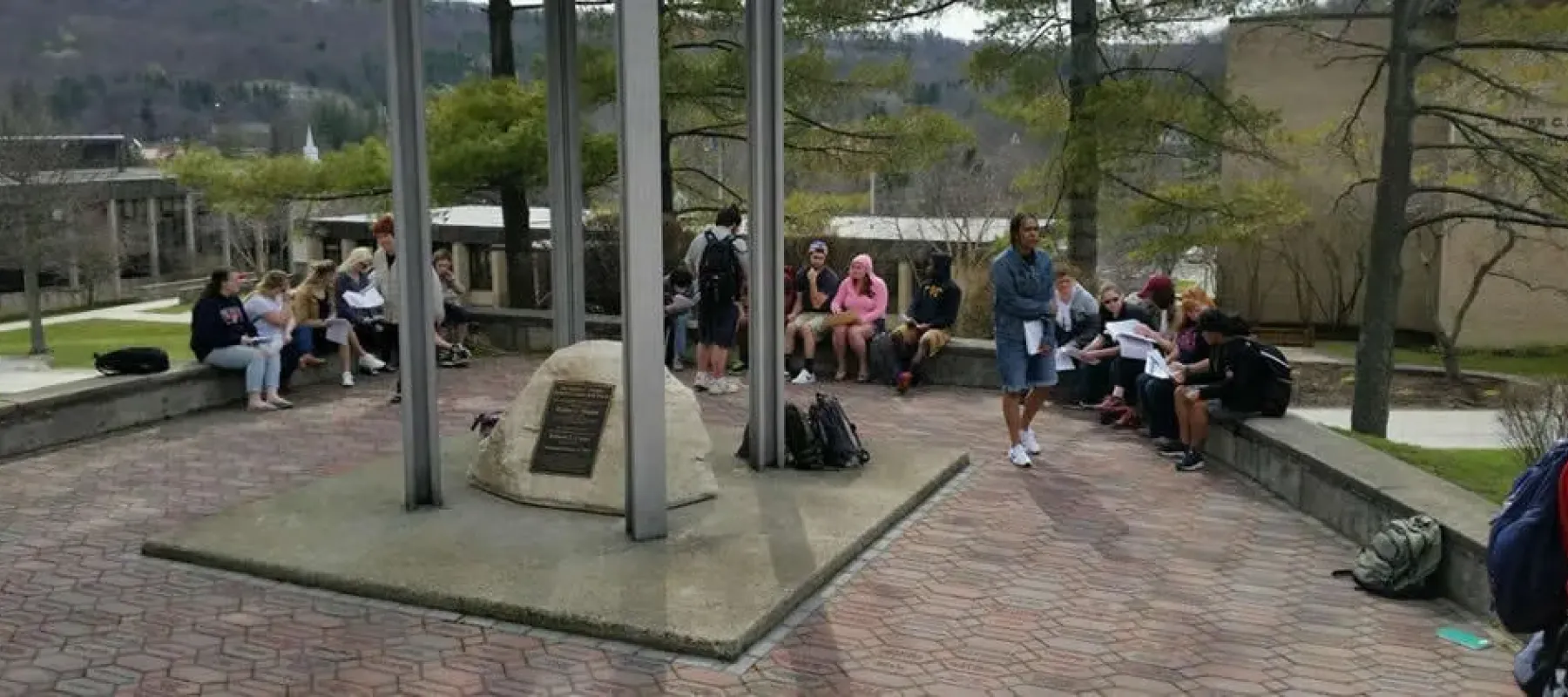 Students gathered outside by the Alfred State bell tower.